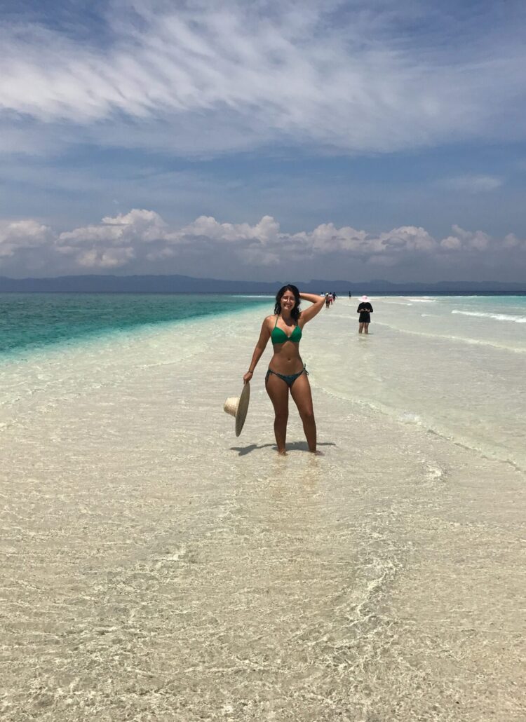 girl in bikini standing on beach in philippines